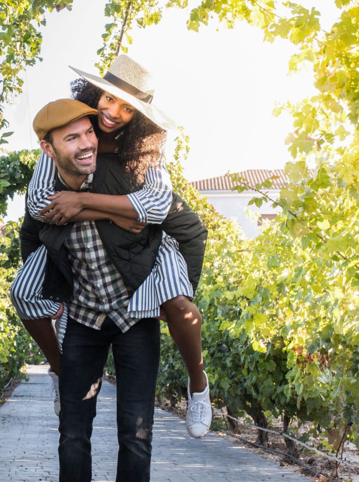 happy young interracial couple on holiday in a vineyard